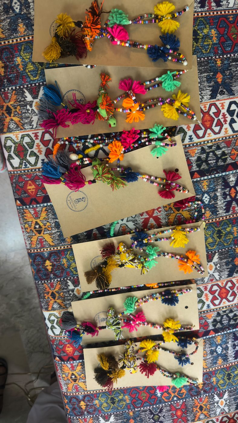 Tassel and bead necklace with a fabric bird